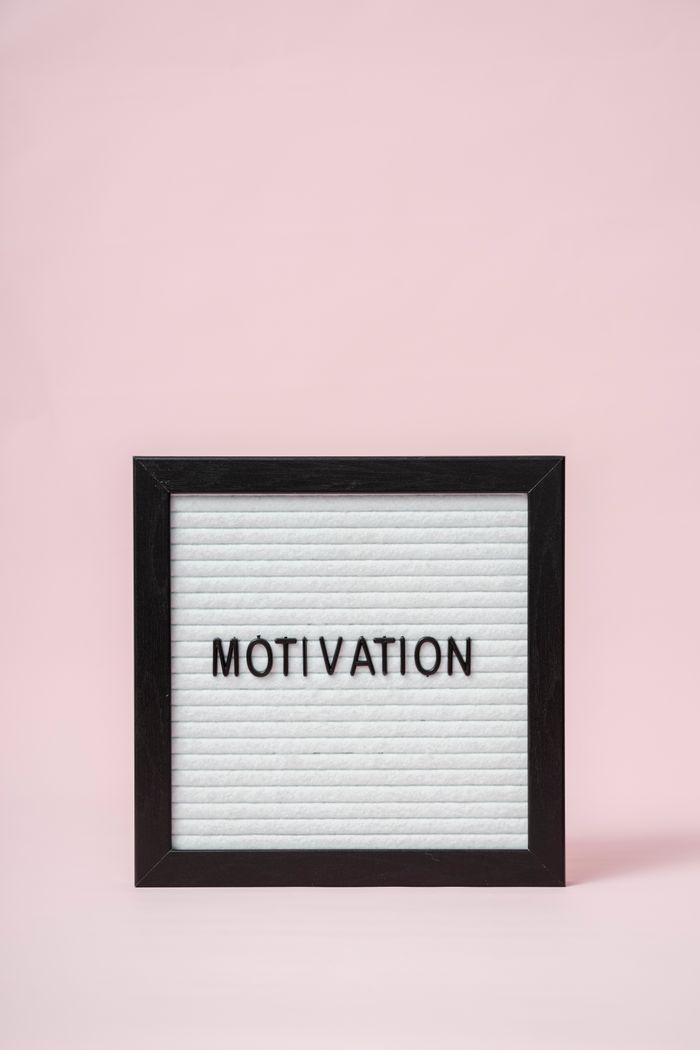 A letter board with 'Motivation' text on a soft pink background, perfect for inspirational themes.