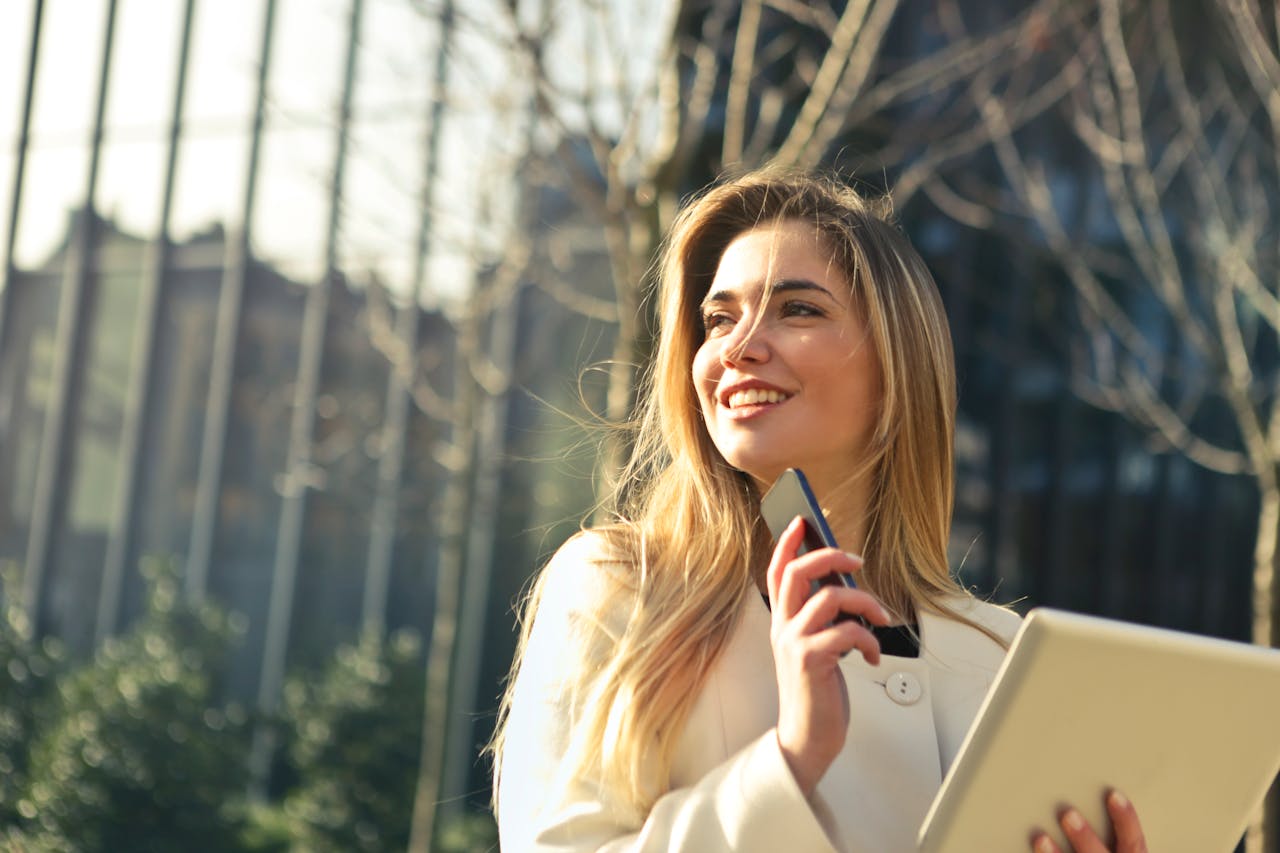 Woman Wearing White Top Holding Smartphone And Tablet 864994